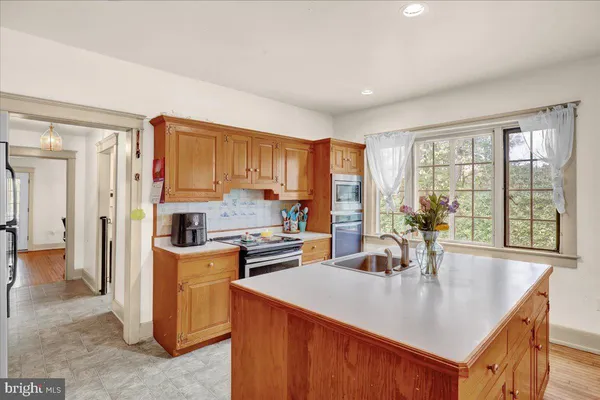 a kitchen with appliances cabinets and a counter top space