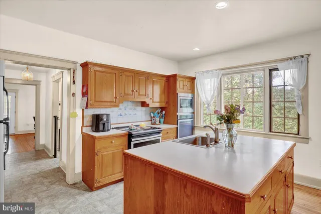 a kitchen with appliances cabinets and a counter top space