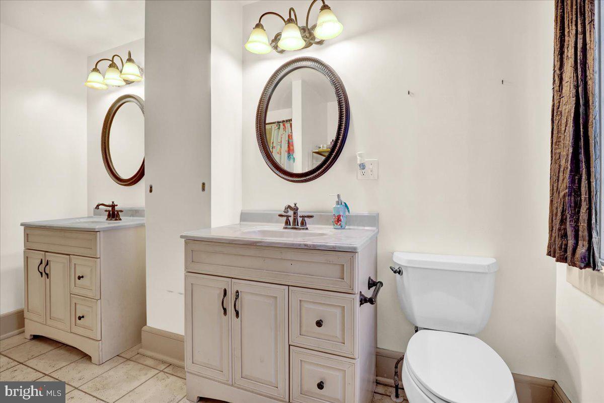 22 Ridge Road Ringtown, PA 17967 - Photo 25 of 46 a bathroom with a granite countertop toilet sink and a mirror