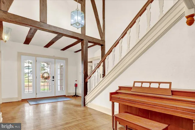 a view of staircase with lots of frames on wall and a window