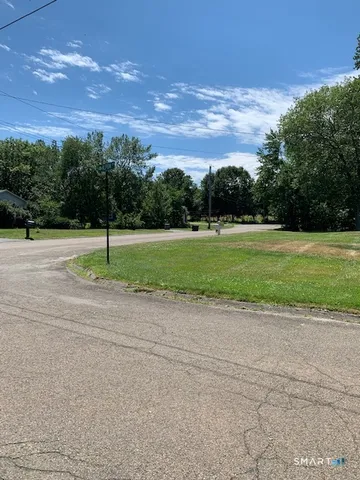 a view of a field of grass and trees