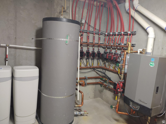 2170 Highway 357 Beaver, UT 84713 - Photo 49 of 56 Hydronic heating system with multiple red PEX lines, copper piping, and a large water heater
