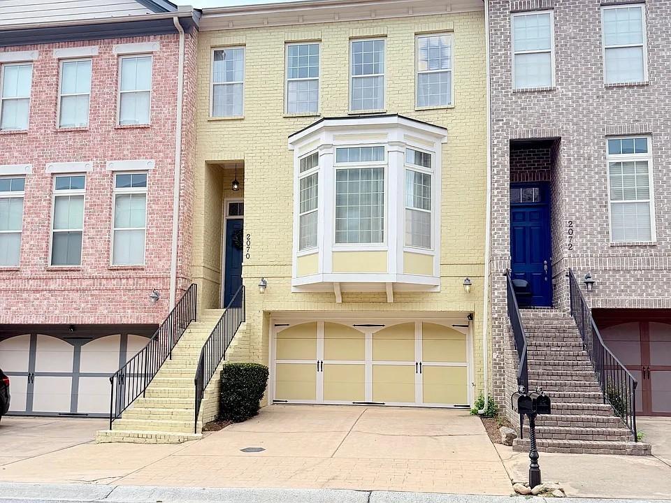 a view of a brick house with many windows