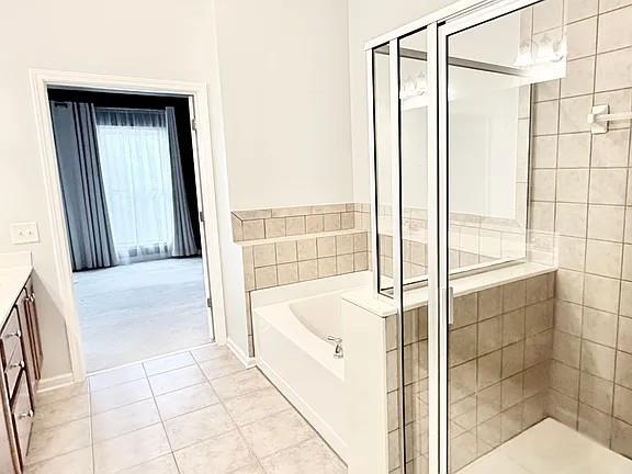 2070 Callaway Court Atlanta, GA 30318 - Photo 16 of 30 a bathroom with a tub and shower