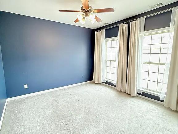 2070 Callaway Court Atlanta, GA 30318 - Photo 19 of 30 an empty room with windows and chandelier fan