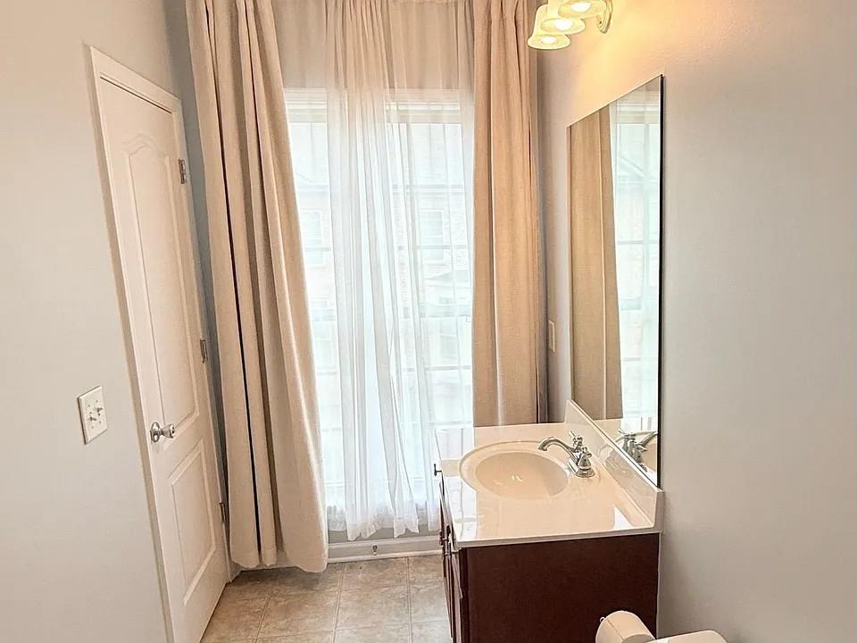 2070 Callaway Court Atlanta, GA 30318 - Photo 20 of 30 a bathroom with a sink and a mirror