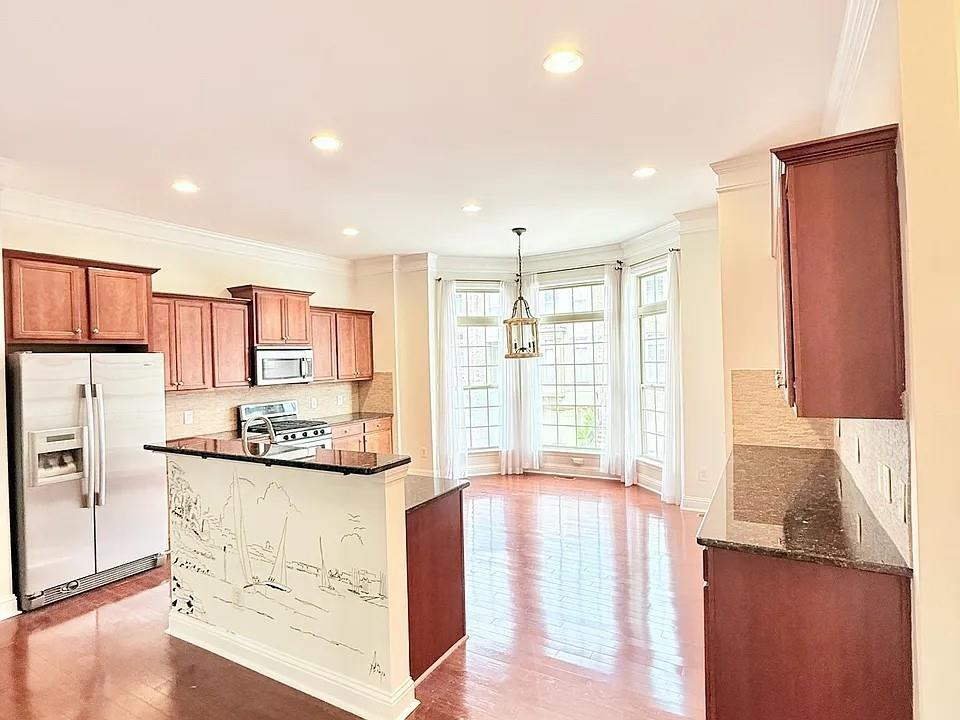 2070 Callaway Court Atlanta, GA 30318 - Photo 2 of 30 a kitchen with stainless steel appliances kitchen island granite countertop a refrigerator and a stove top oven