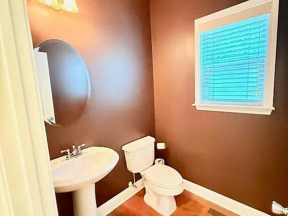 2070 Callaway Court Atlanta, GA 30318 - Photo 10 of 30 a bathroom with a toilet sink and mirror