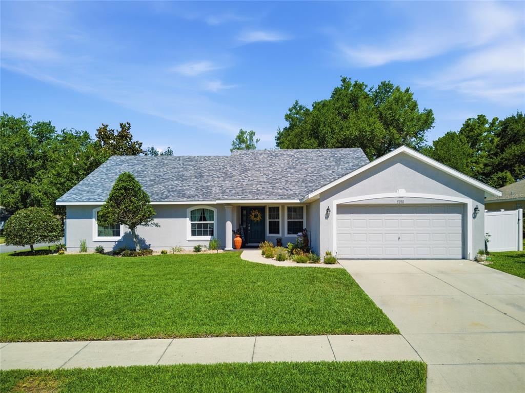a front view of a house with a yard and garage