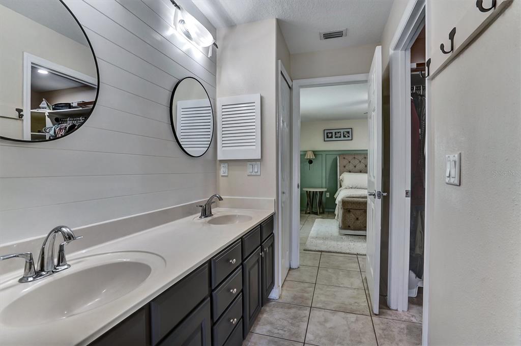 5010 Treasure Cay Road Tavares, FL 32778 - Photo 14 of 32 a bathroom with a double vanity sink and a mirror