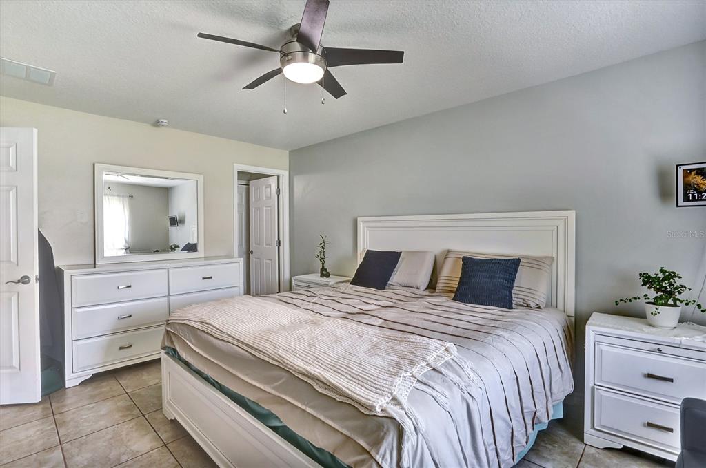 5010 Treasure Cay Road Tavares, FL 32778 - Photo 15 of 32 a bedroom with a bed and a dresser