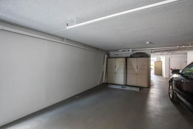 a view of swimming pool with lawn chairs potted plants