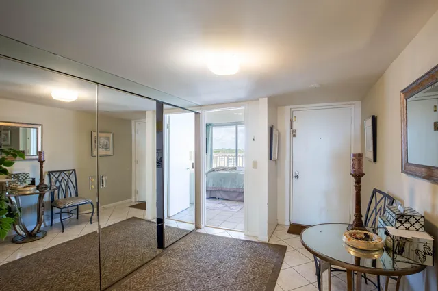 a view of a hallway with wooden floor and a dining table