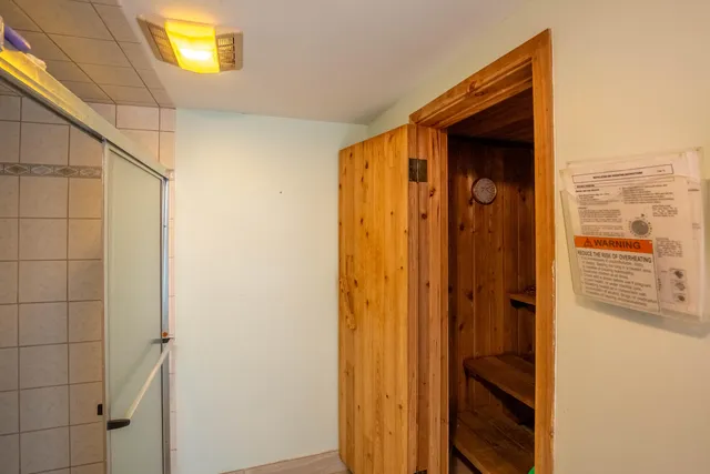 a bedroom with a large bed and a painting