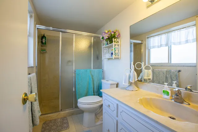 a white vase with flowers