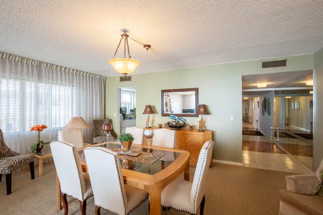 a dining room with furniture and a chandelier