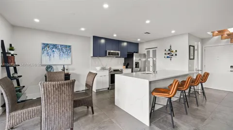 a dining room with furniture a window and kitchen view