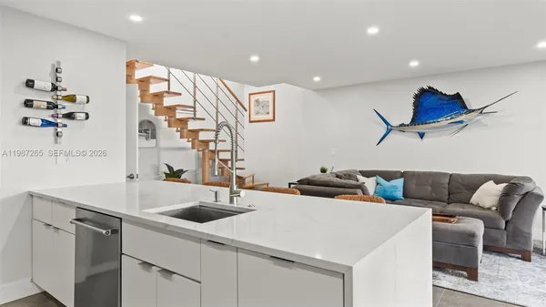 a kitchen with cabinets and wooden floor