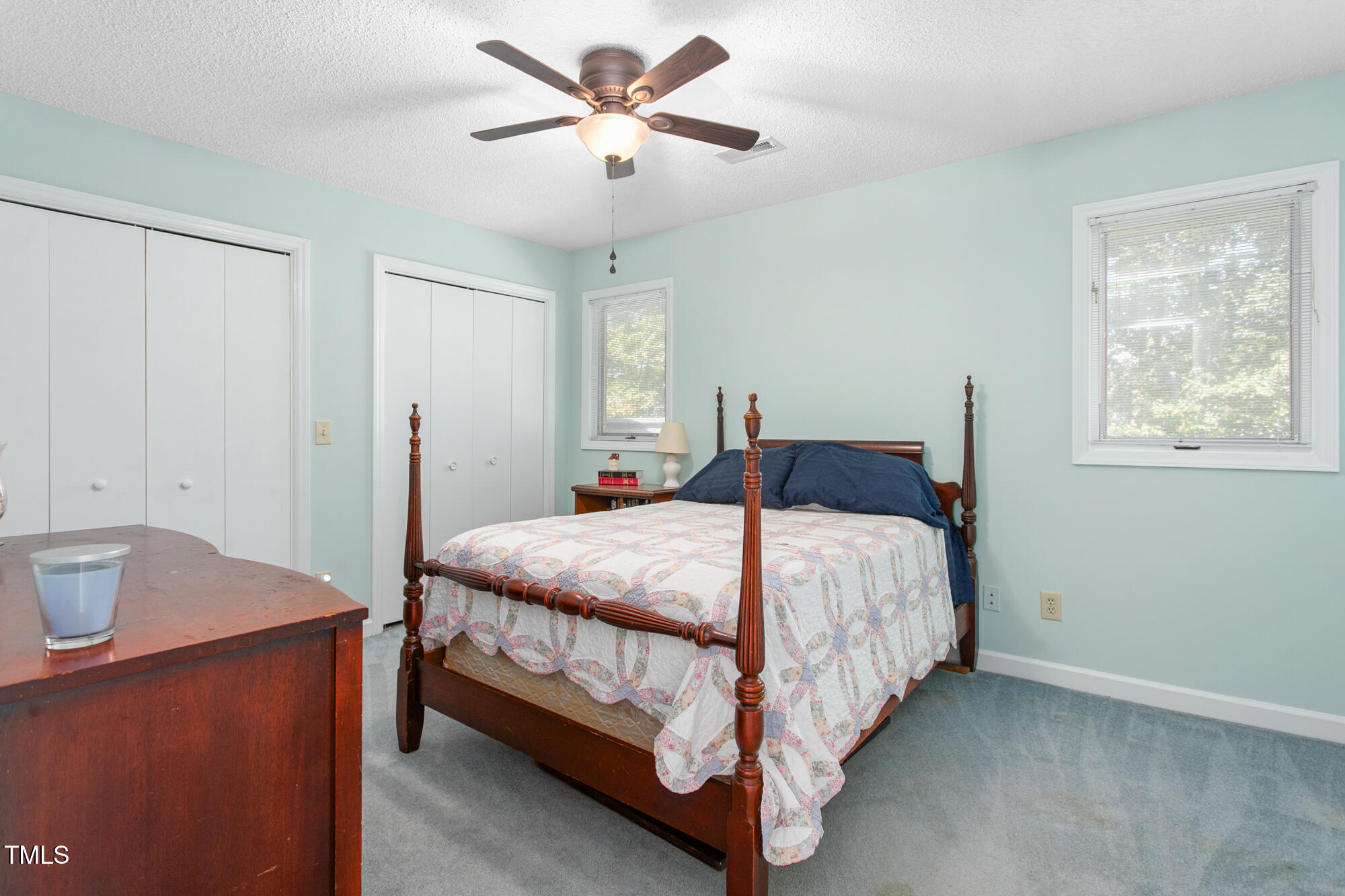 809 Brookview Drive Elon, NC 27244 - Photo 30 of 53 a bedroom with a bed and a chandelier