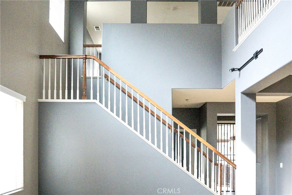 1373 Aztec Court Beaumont, CA 92223 - Photo 20 of 56 a view of staircase with lots of frames on wall and a window