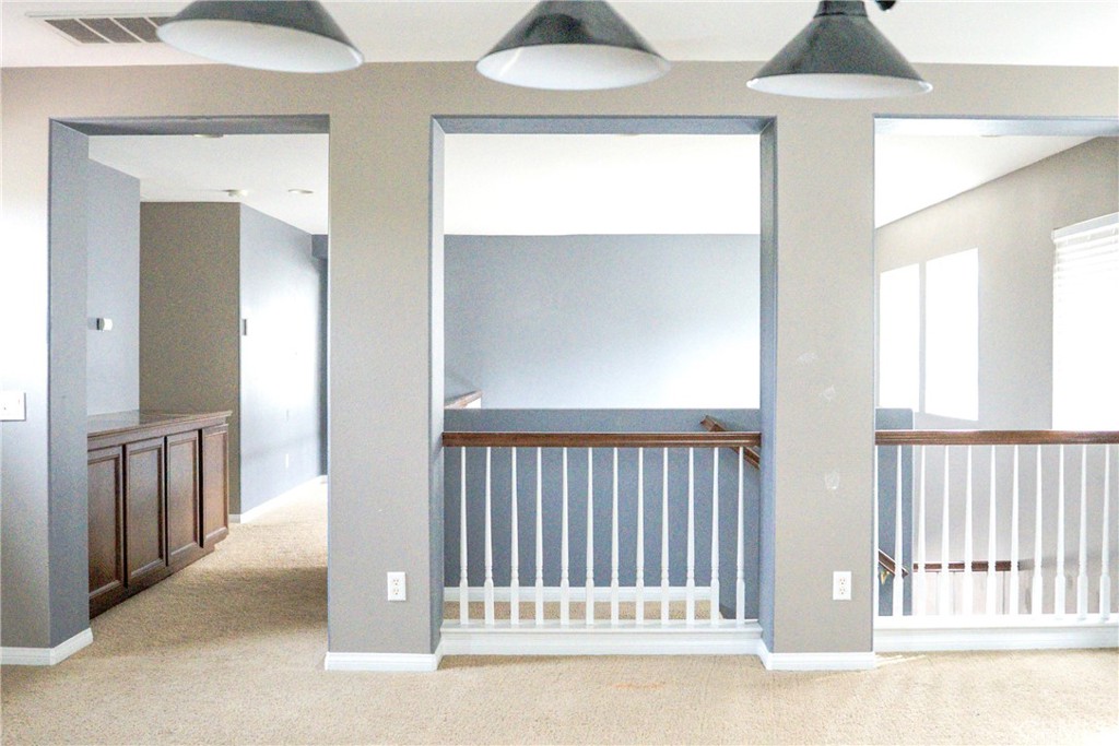 1373 Aztec Court Beaumont, CA 92223 - Photo 25 of 56 a view of a hallway and a livingroom with a chandelier