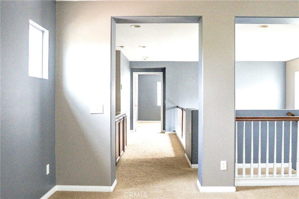 1373 Aztec Court Beaumont, CA 92223 - Photo 27 of 56 a view of a hallway with wooden floor and a living room