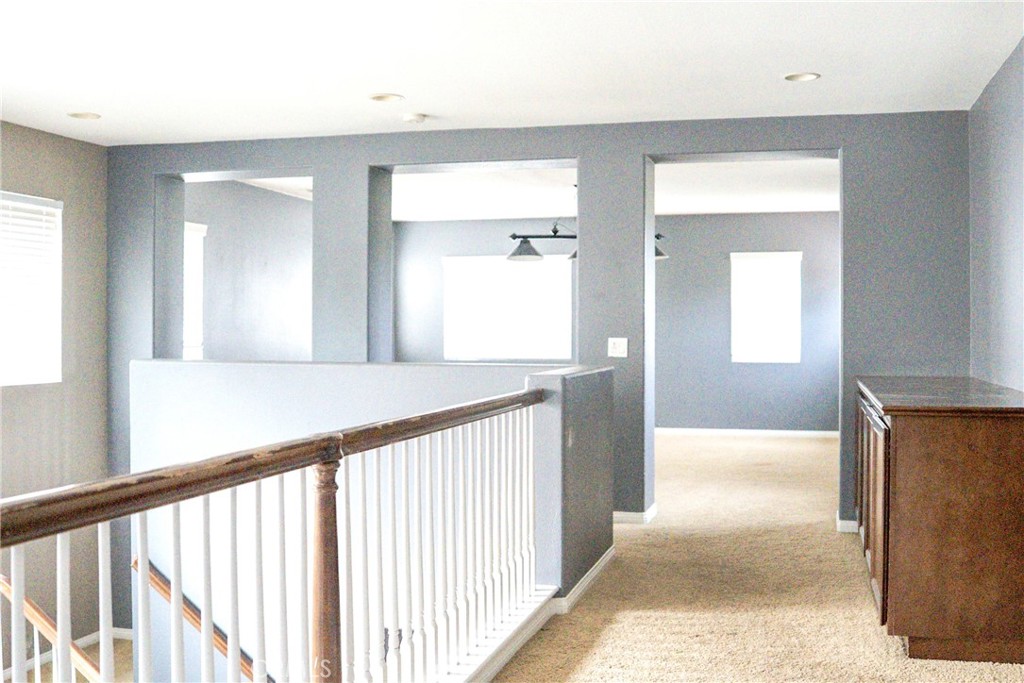 1373 Aztec Court Beaumont, CA 92223 - Photo 28 of 56 a view of a hallway view with wooden floor and staircase