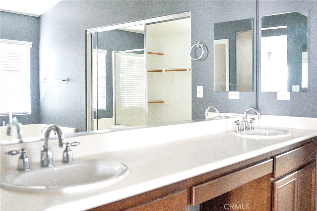 1373 Aztec Court Beaumont, CA 92223 - Photo 32 of 56 a bathroom with a sink and a mirror