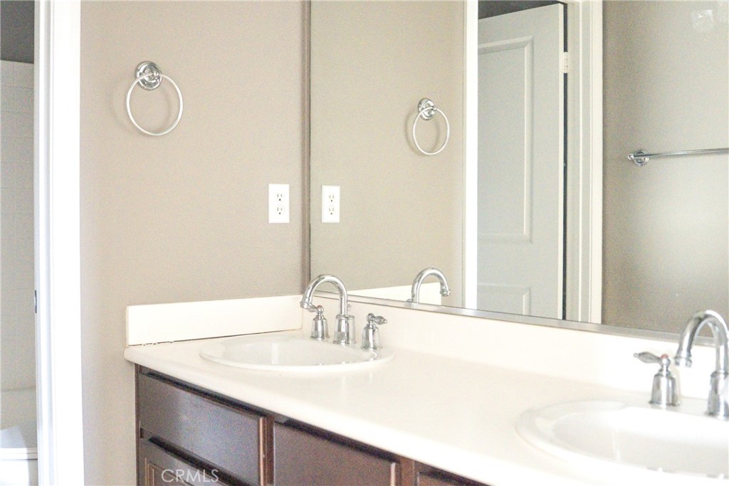 1373 Aztec Court Beaumont, CA 92223 - Photo 42 of 56 a bathroom with a sink and a mirror