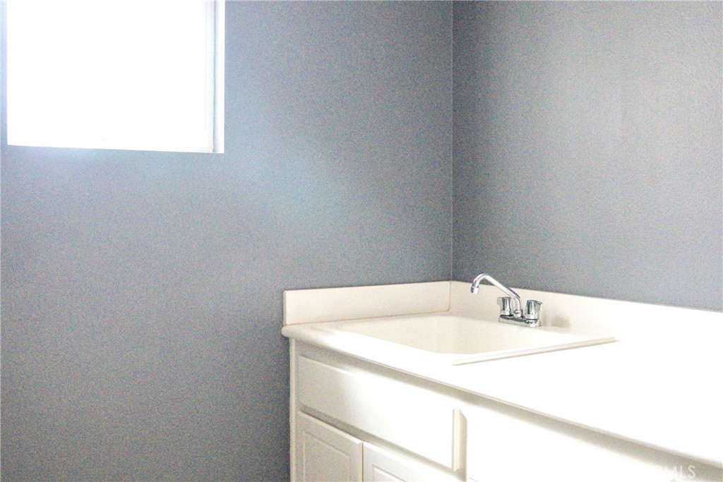 1373 Aztec Court Beaumont, CA 92223 - Photo 44 of 56 a bathroom with a sink and a mirror