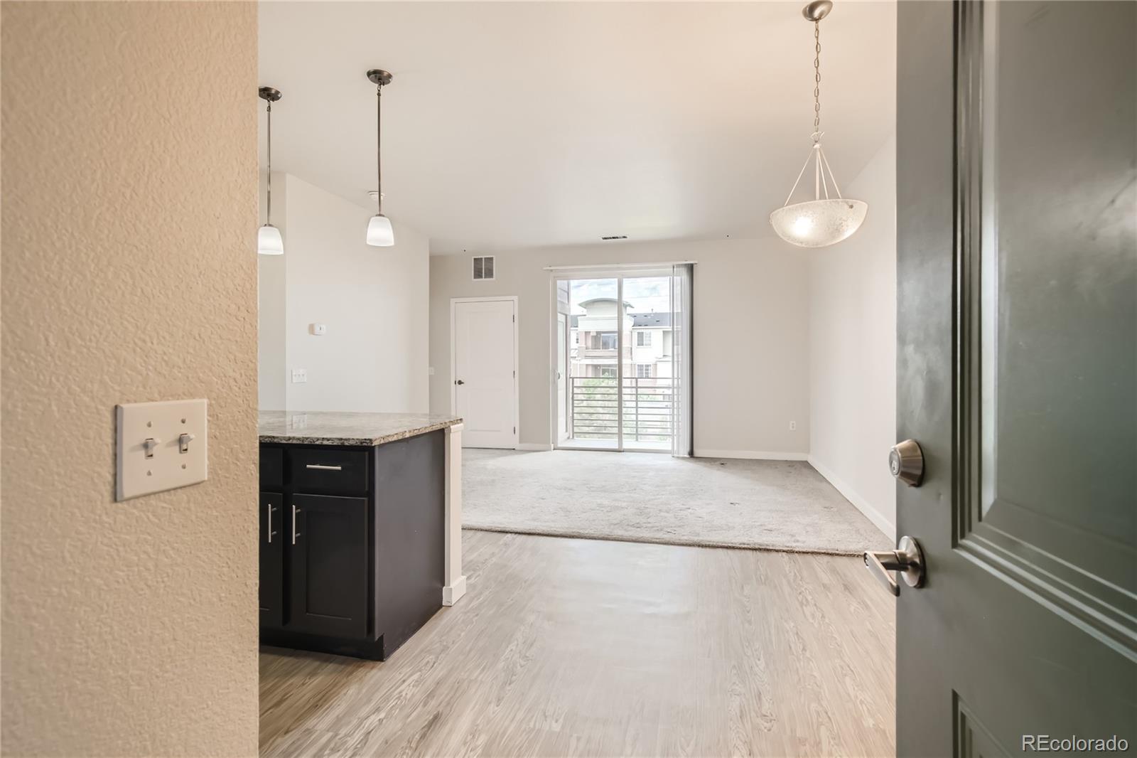 4100 Albion Street, Unit 514 Denver, CO 80216 - Photo 1 of 31 a view of an empty room with window and cabinet