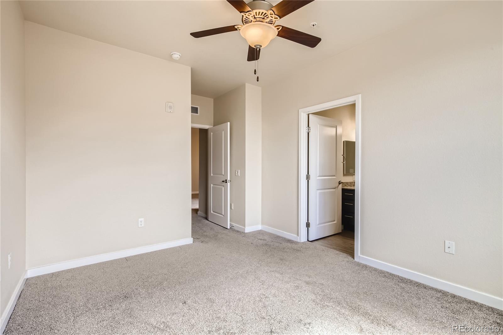 4100 Albion Street, Unit 514 Denver, CO 80216 - Photo 12 of 31 a view of a livingroom with a ceiling fan and window