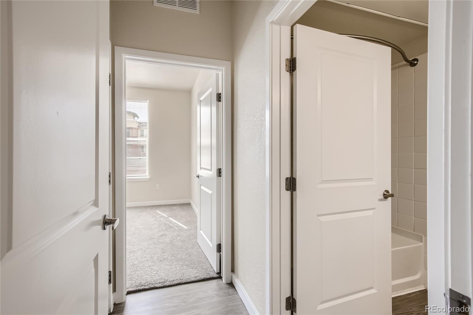 4100 Albion Street, Unit 514 Denver, CO 80216 - Photo 17 of 31 a view of a bathroom from a hallway