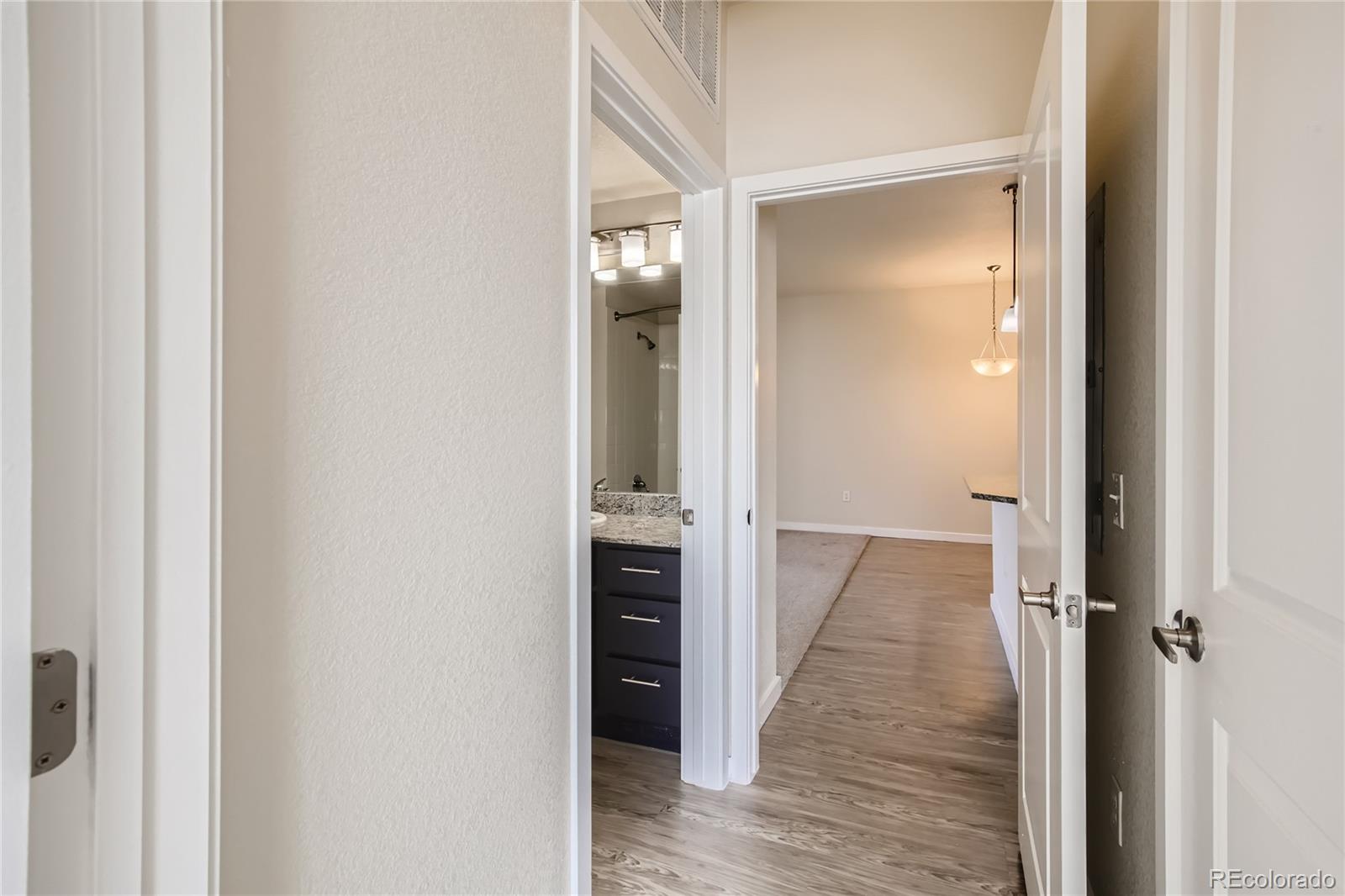 4100 Albion Street, Unit 514 Denver, CO 80216 - Photo 18 of 31 a view of a hallway with wooden floor and staircase