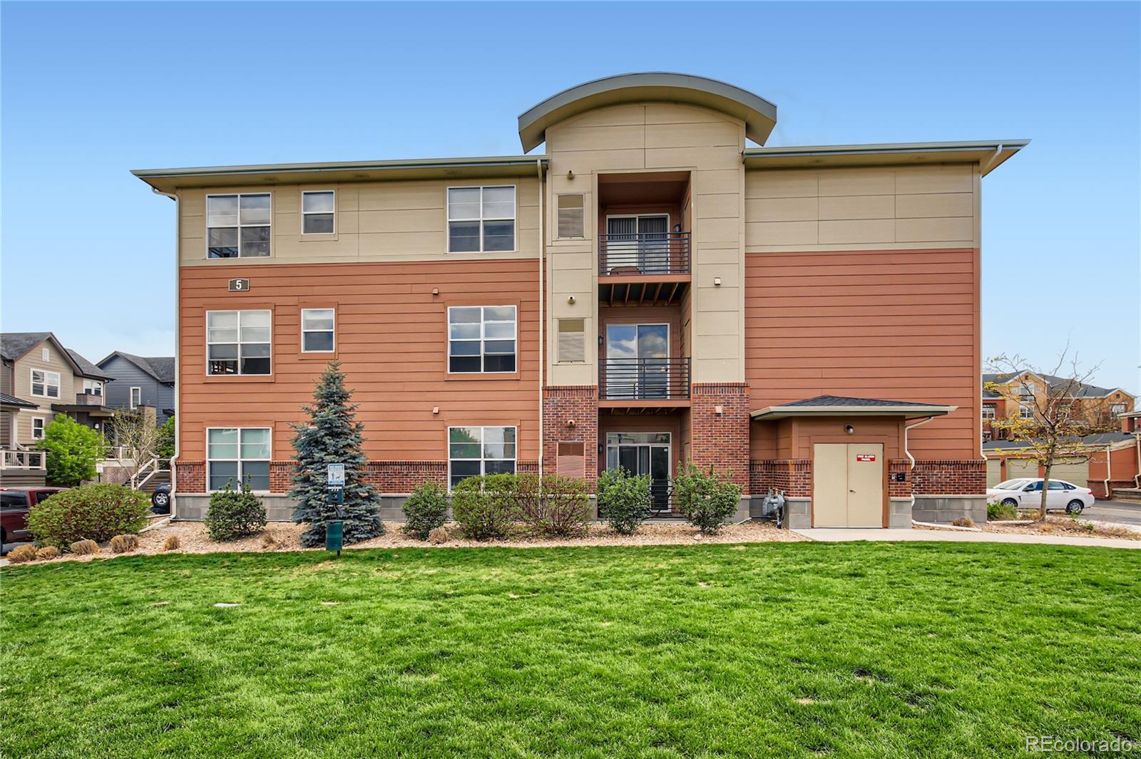 4100 Albion Street, Unit 514 Denver, CO 80216 - Photo 24 of 31 a front view of a house with a garden