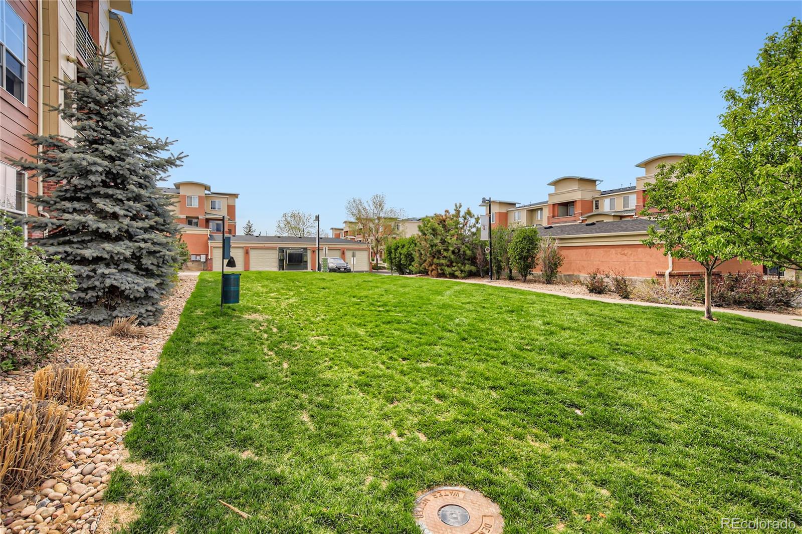 4100 Albion Street, Unit 514 Denver, CO 80216 - Photo 25 of 31 a backyard of a house with lots of green space