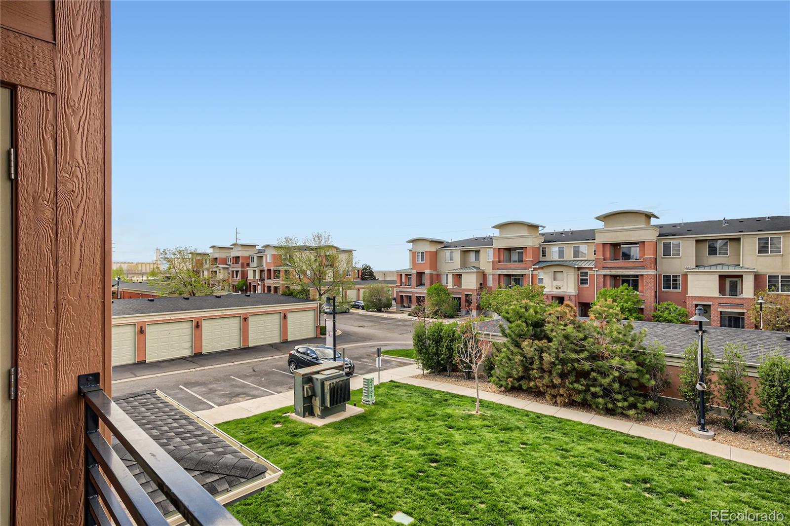 4100 Albion Street, Unit 514 Denver, CO 80216 - Photo 26 of 31 a view of a city from a chairs and table in the balcony