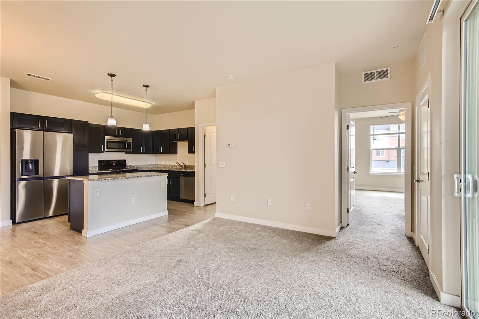 4100 Albion Street, Unit 514 Denver, CO 80216 - Photo 6 of 31 a view of kitchen with refrigerator sink and cabinets