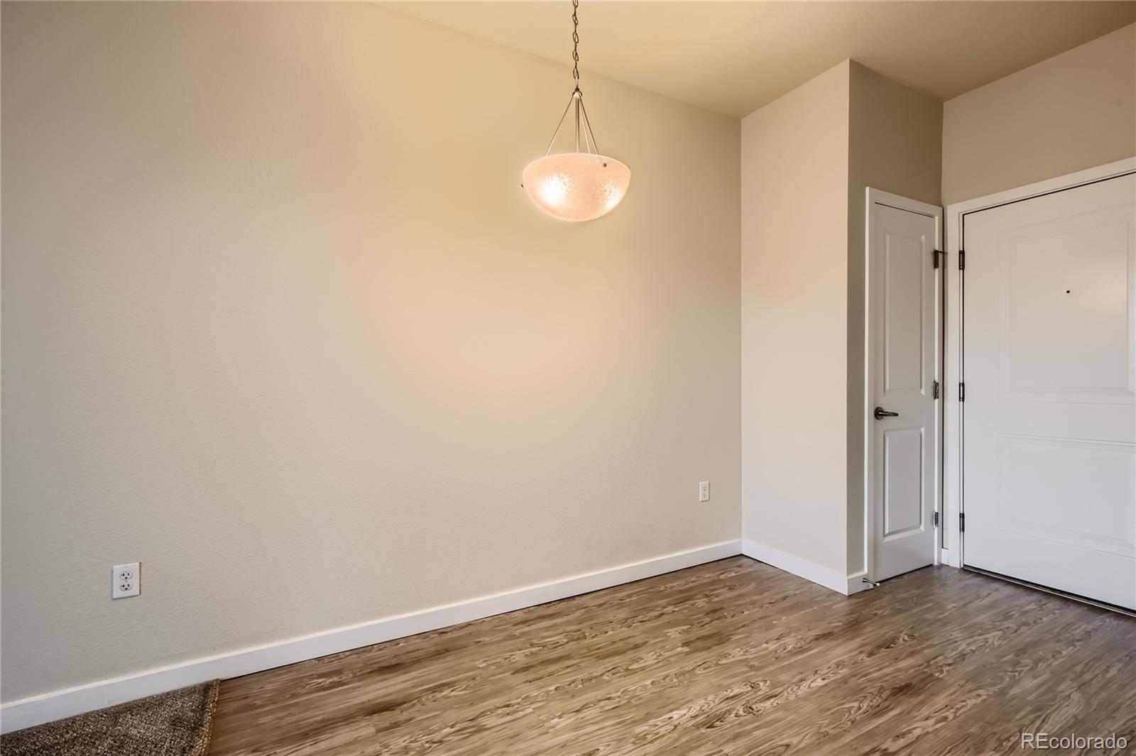 4100 Albion Street, Unit 514 Denver, CO 80216 - Photo 10 of 31 a view of an empty room with wooden floor and a window