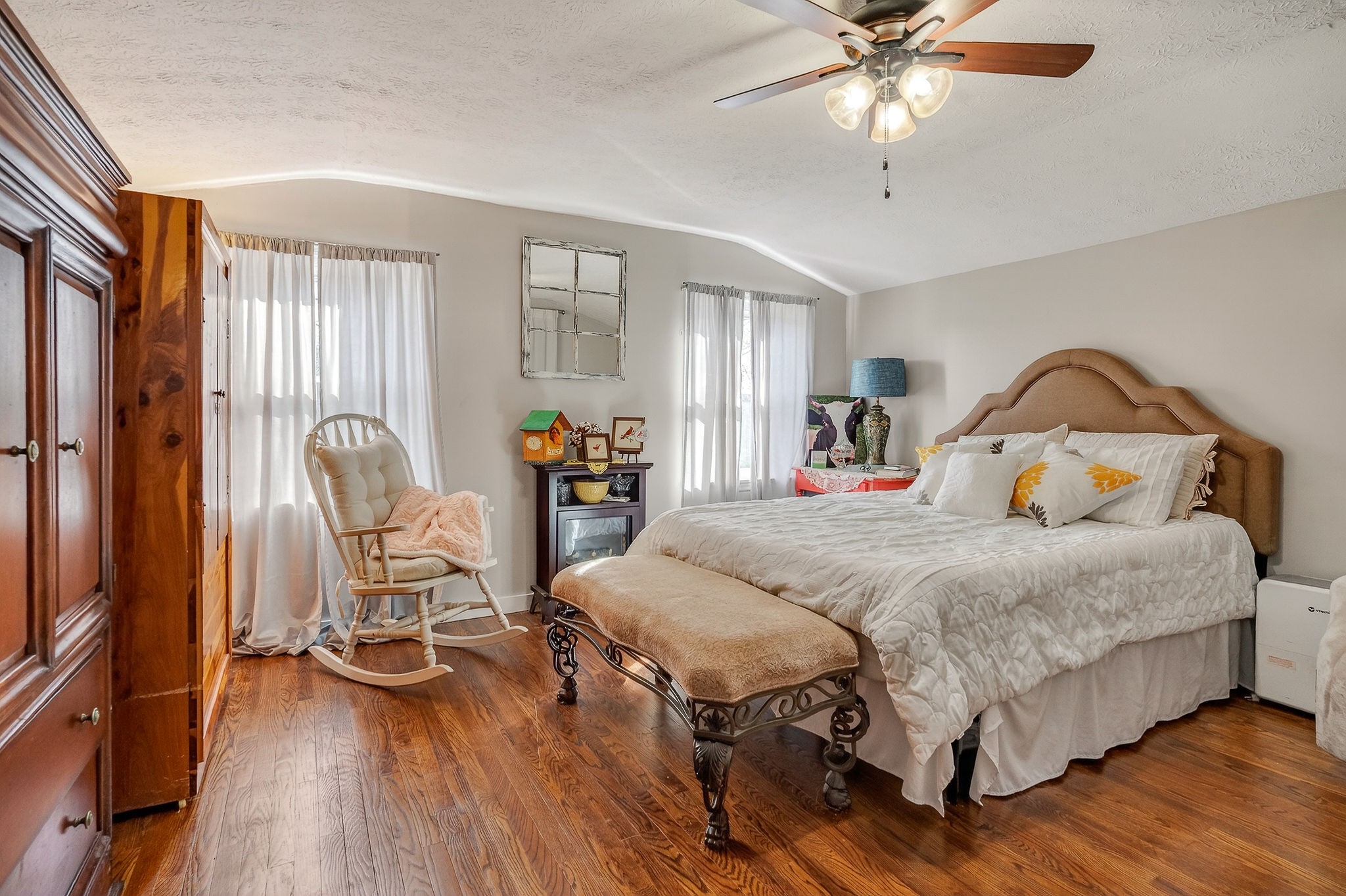 1603 Coon Hunt Road Baxter, TN 38544 - Photo 27 of 51 a bedroom with a bed chairs and wooden floor