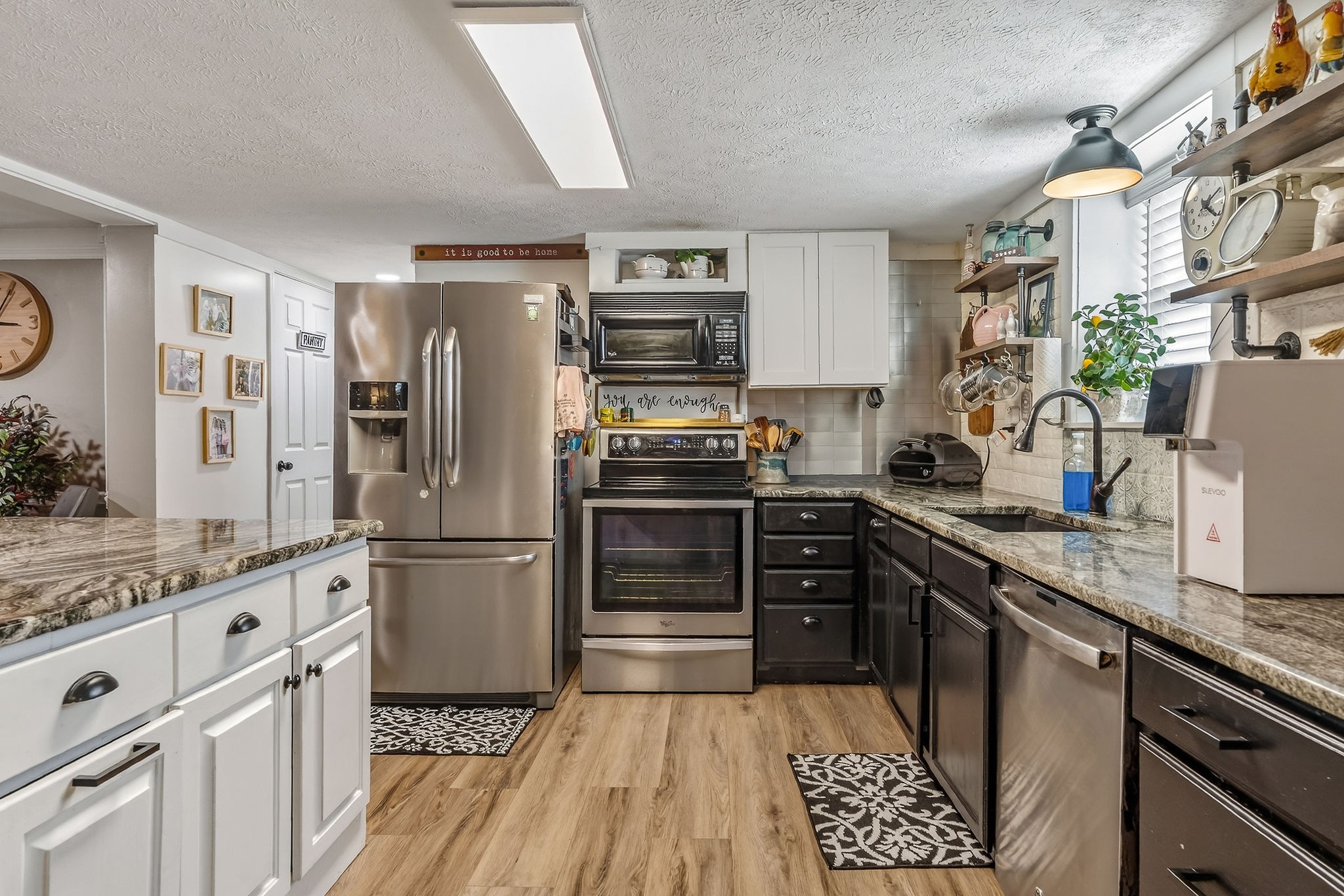 1603 Coon Hunt Road Baxter, TN 38544 - Photo 5 of 51 a kitchen with granite countertop stainless steel appliances and wooden cabinets