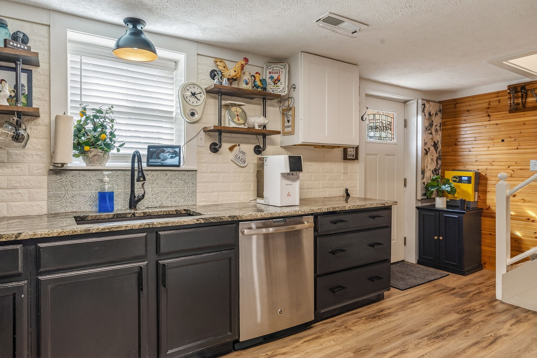 1603 Coon Hunt Road Baxter, TN 38544 - Photo 6 of 51 a kitchen with stainless steel appliances granite countertop a sink a stove a refrigerator wooden floor and cabinets