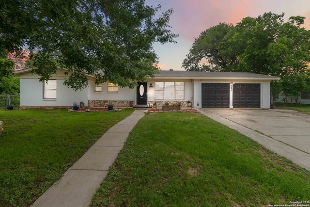 a front view of house with yard and green space