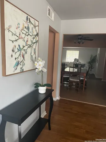 a dining room with furniture and wooden floor