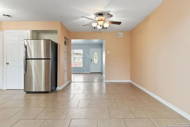 a view of a kitchen with a refrigerator and a chandelier