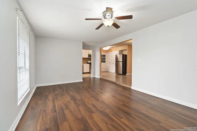 wooden floor in an empty room with a window