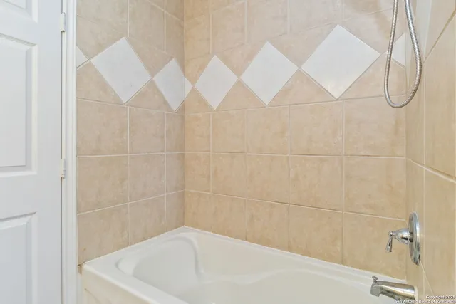a bathroom with a white bathtub