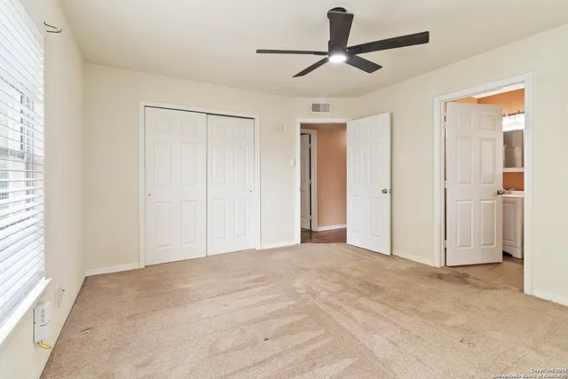 a view of empty room with ceiling fan