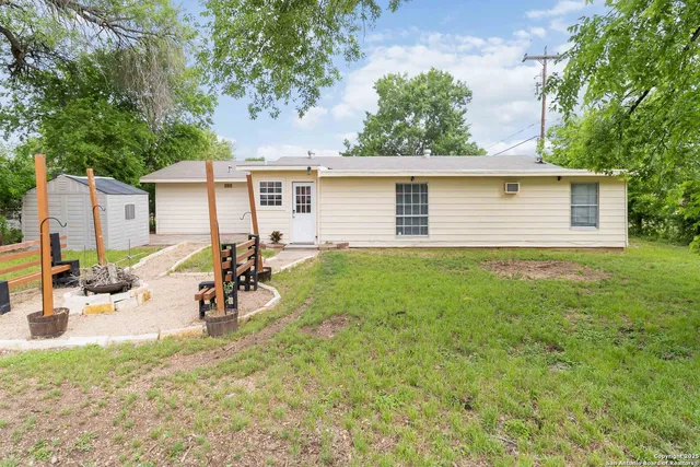 a view of a backyard with a sitting area