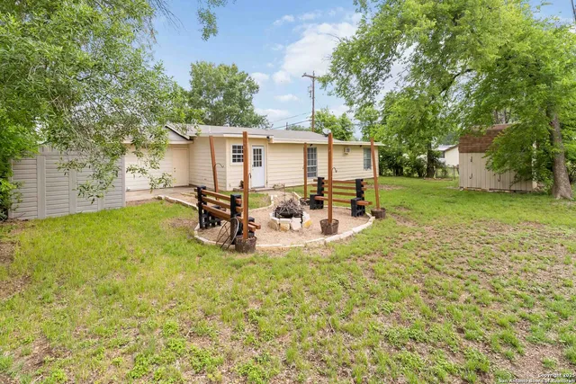 a view of a house with backyard porch and sitting area